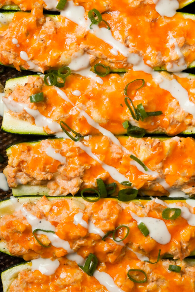buffalo chicken zucchinis topped with ranch dressing drizzle