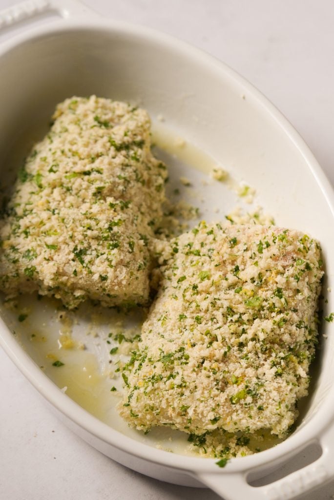 cod fillets coated in a panko parmesan breadcrumb mixture before baking