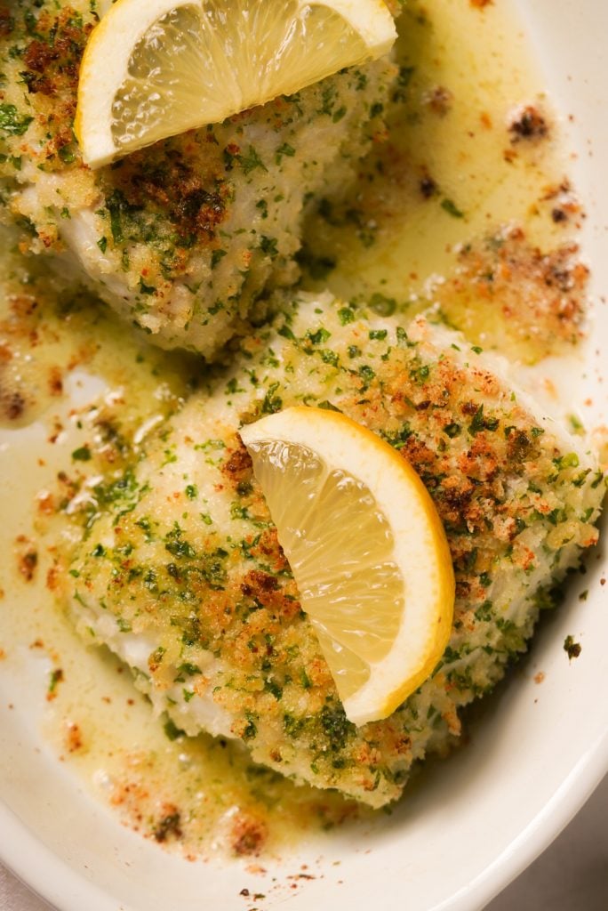 crusted cod fillets with lemon wedges