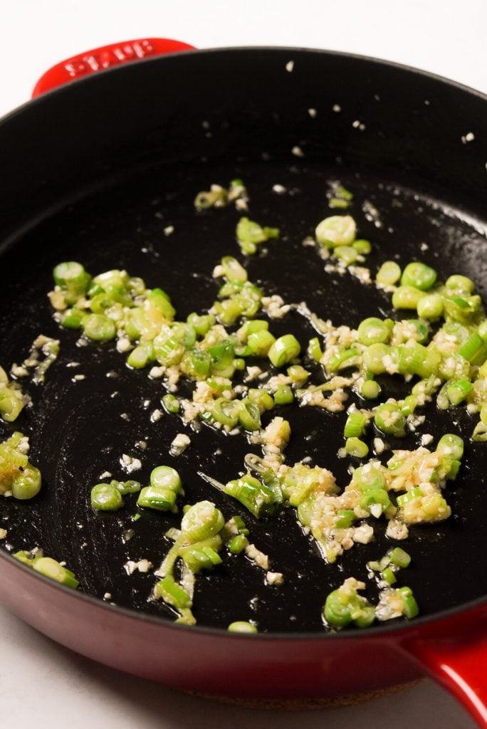 minced ginger, minced garlic, green onion, and sesame oil in a skillet