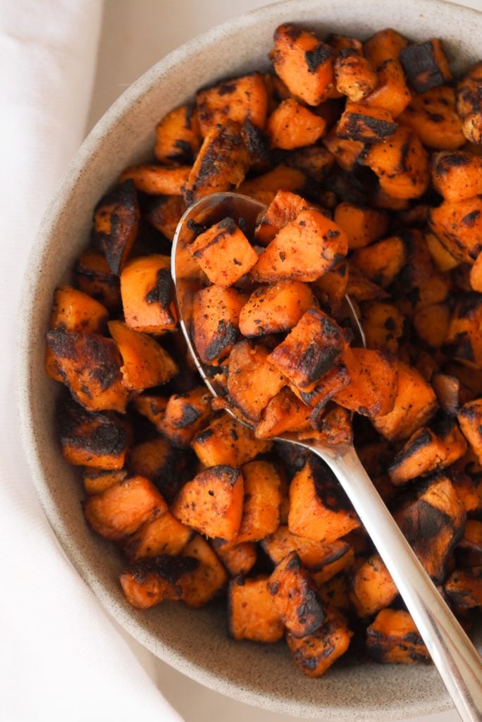bowl of sweet potatoes with a spoon