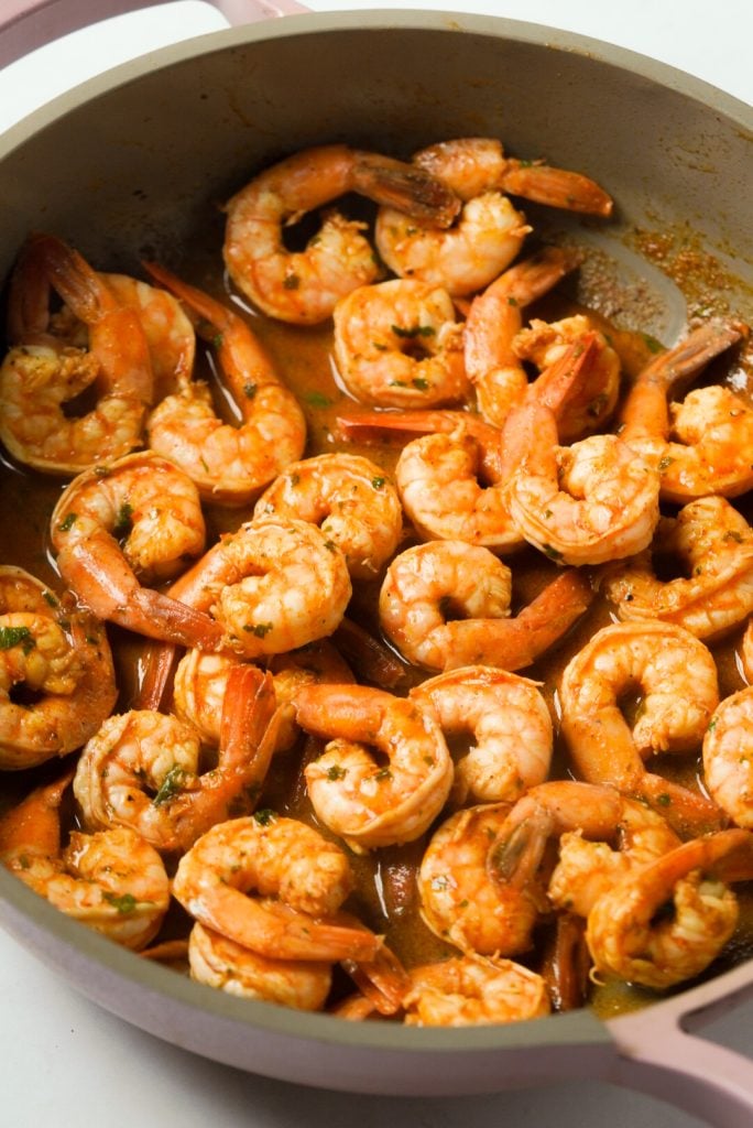seasoned and sautéed shrimp in a large pan