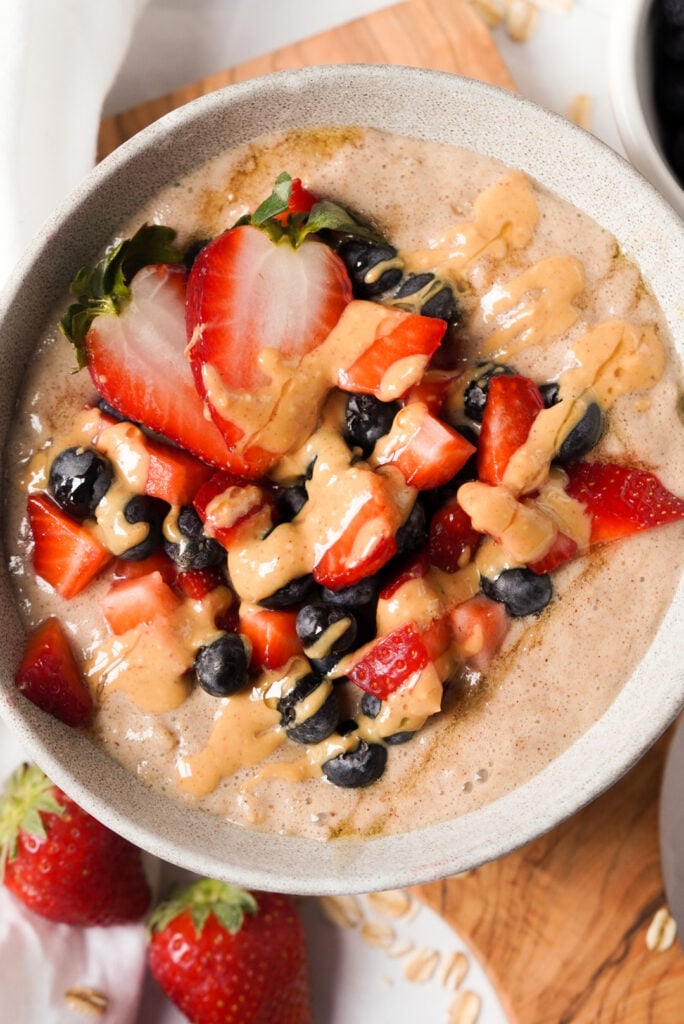 bowl of egg white oatmeal with peanut butter and berries