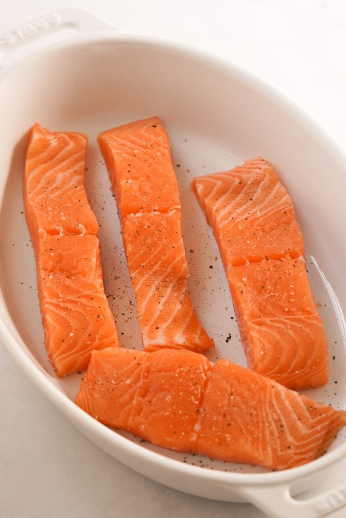 salmon fillets with salt and pepper in a baking dish