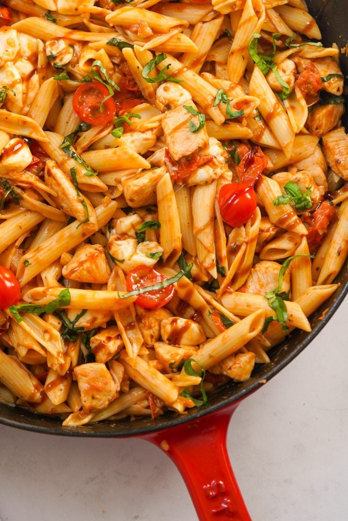 penne pasta with tomatoes, fresh basil, chicken, and melty mozzarella