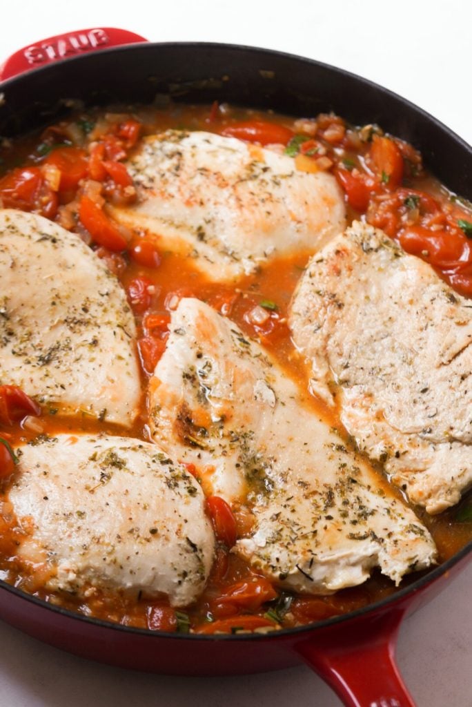 seared chicken breasts added back to the skillet with the pomodori sauce.
