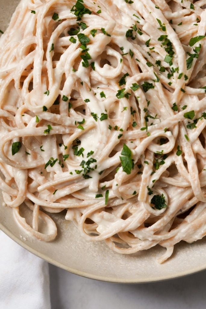 bowl of linguini pasta topped with high protein alfredo sauce
