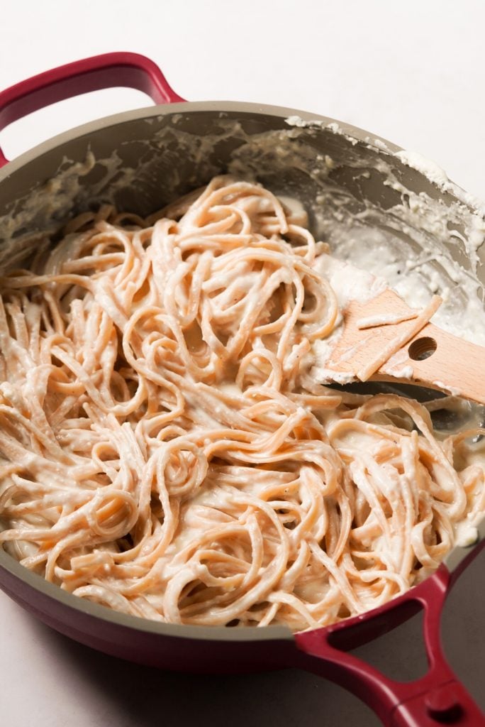 linguini tossed with greek yogurt pasta sauce in a pan