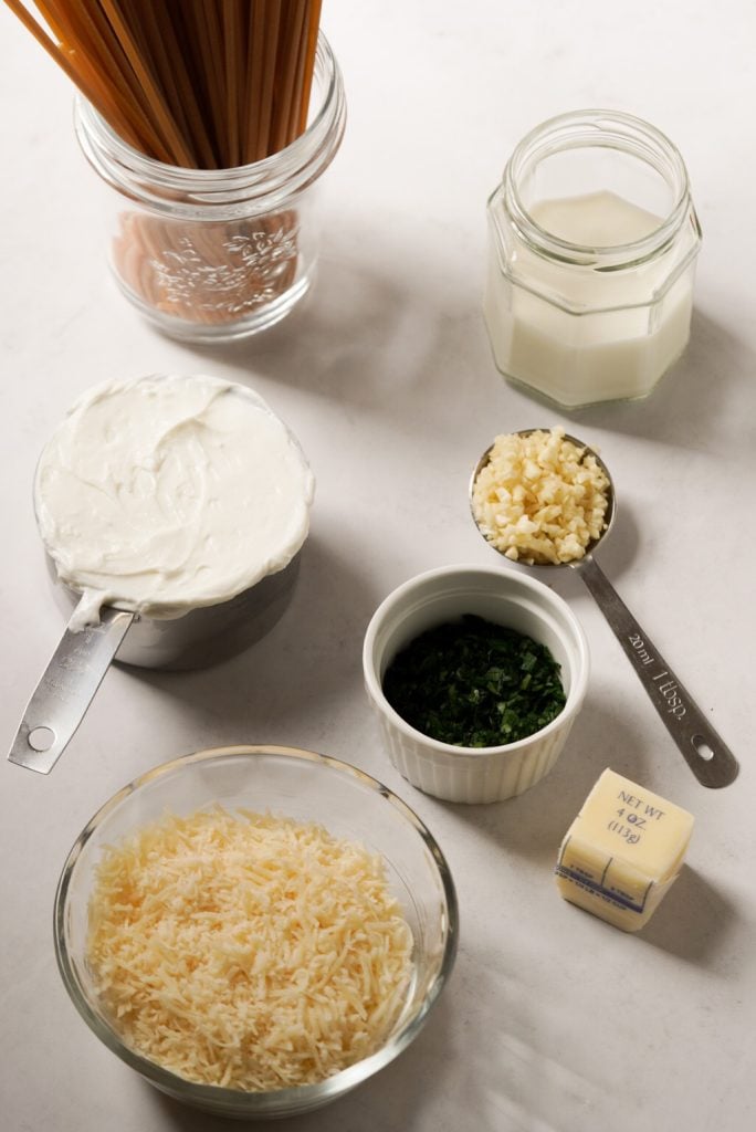 greek yogurt alfredo ingredients measured out on a white table