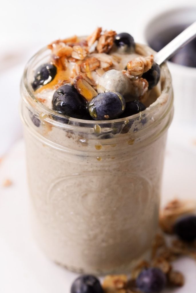 hero shot of a jar of overnight blended oats with toppings and spoon