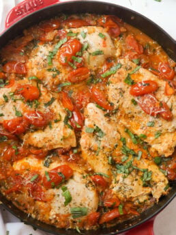 overhead hero shot of a red staub skillet filled with stovetop chicken pomodoro.