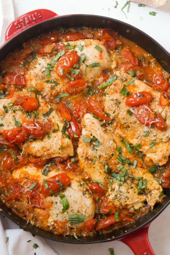 overhead hero shot of a red staub skillet filled with stovetop chicken pomodoro.