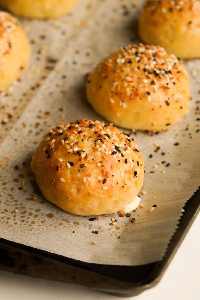 close up shot of a baked everything bagel bite on a baking sheet
