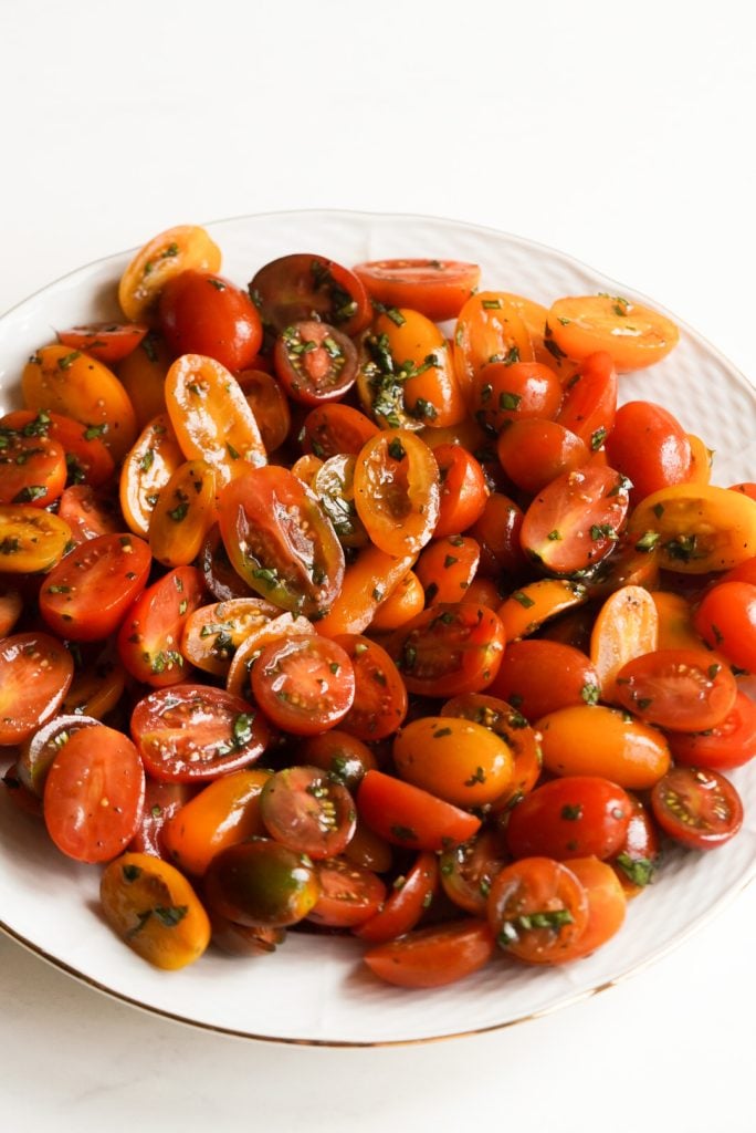 halved cherry tomatoes tossed with oil, seasoning, and fresh basil.