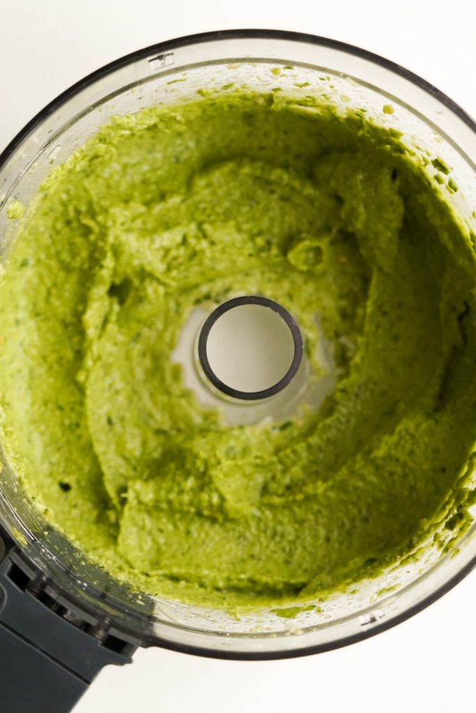 puréed pesto without pine nuts in the base of a food processor.