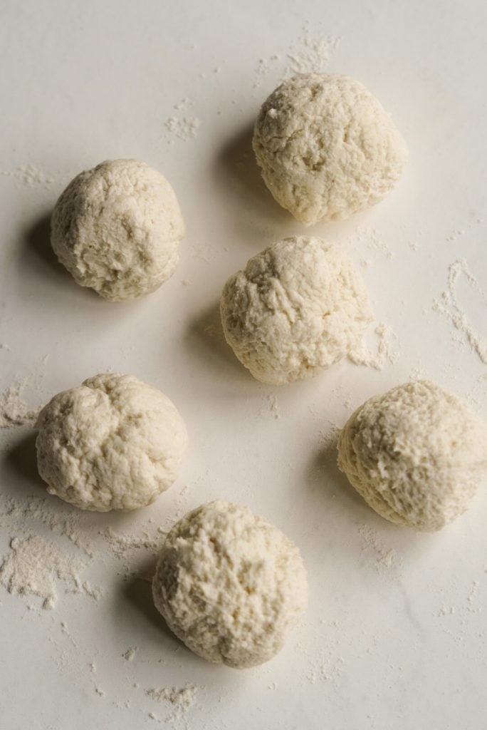 6 bagel bite dough balls on a lightly floured surface