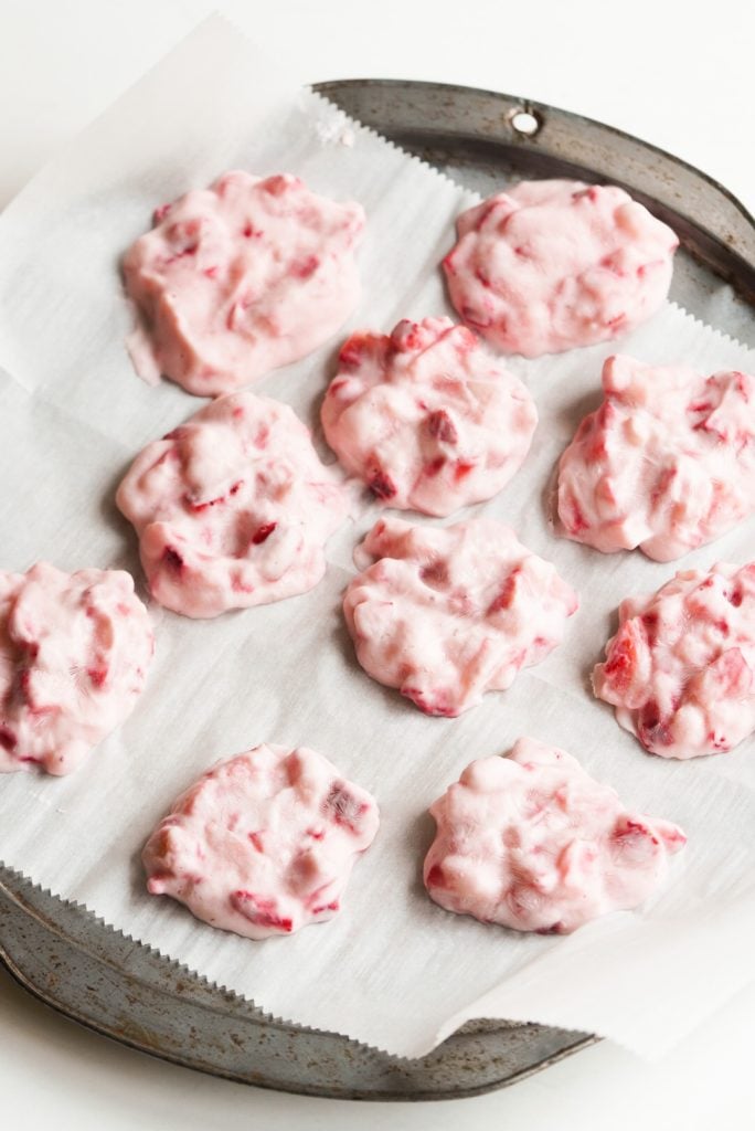 frozen strawberry clusters on a baking sheet