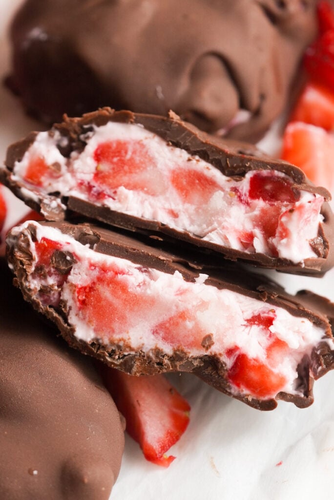 a chocolate covered strawberry yogurt cluster cut in half with the insides shown 