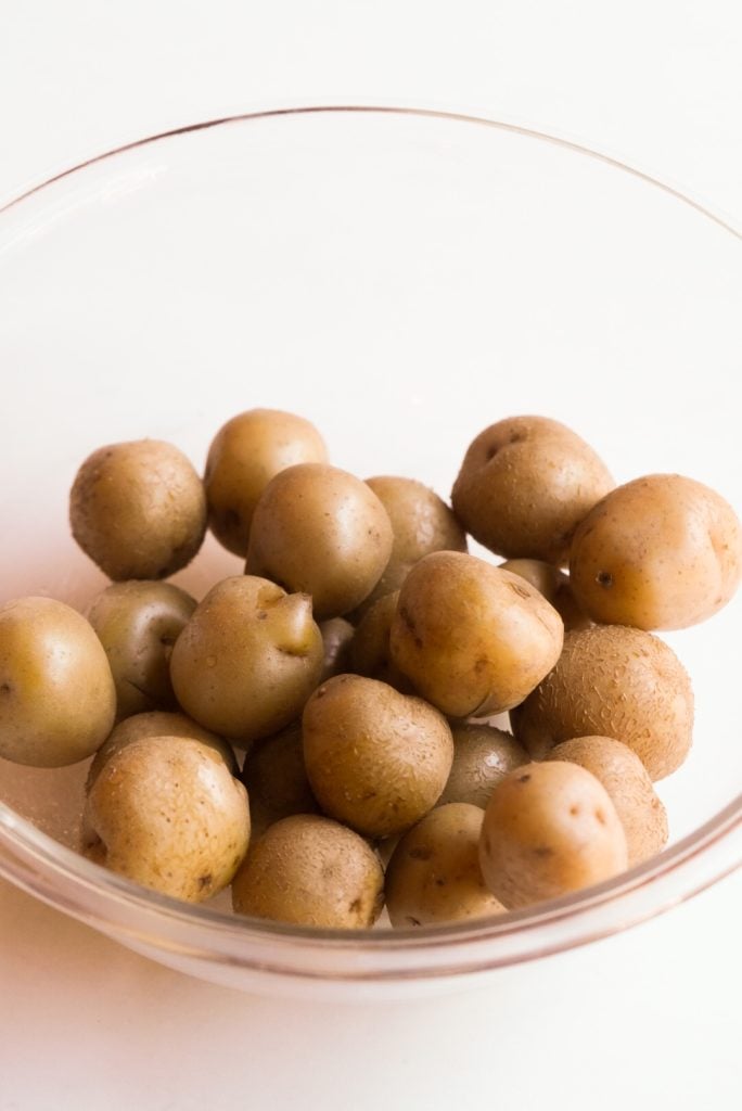 boiled baby potatoes in a mixing bowl