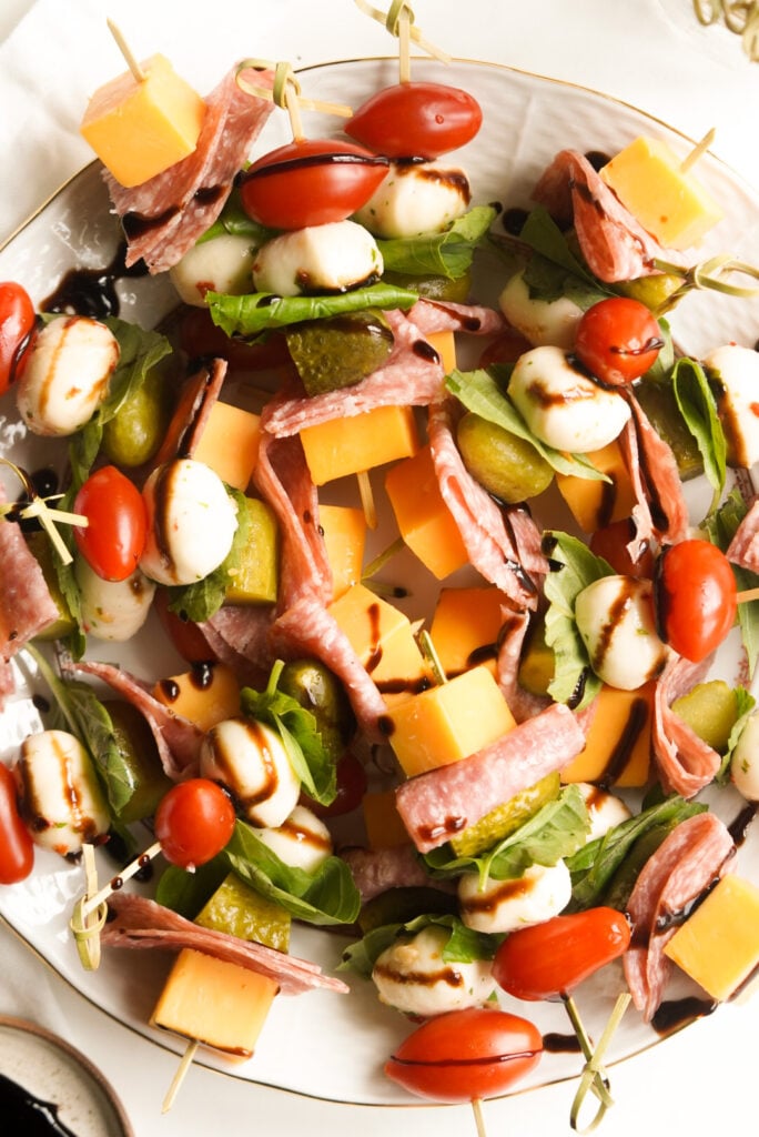 skewers with meat, cheese, basil, pickles, and tomato