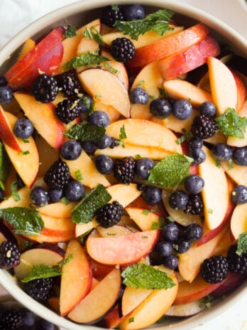 hero shot of a bowl of stone fruit berry salad.