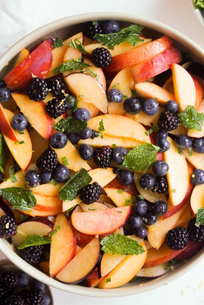 hero shot of a bowl of stone fruit berry salad.