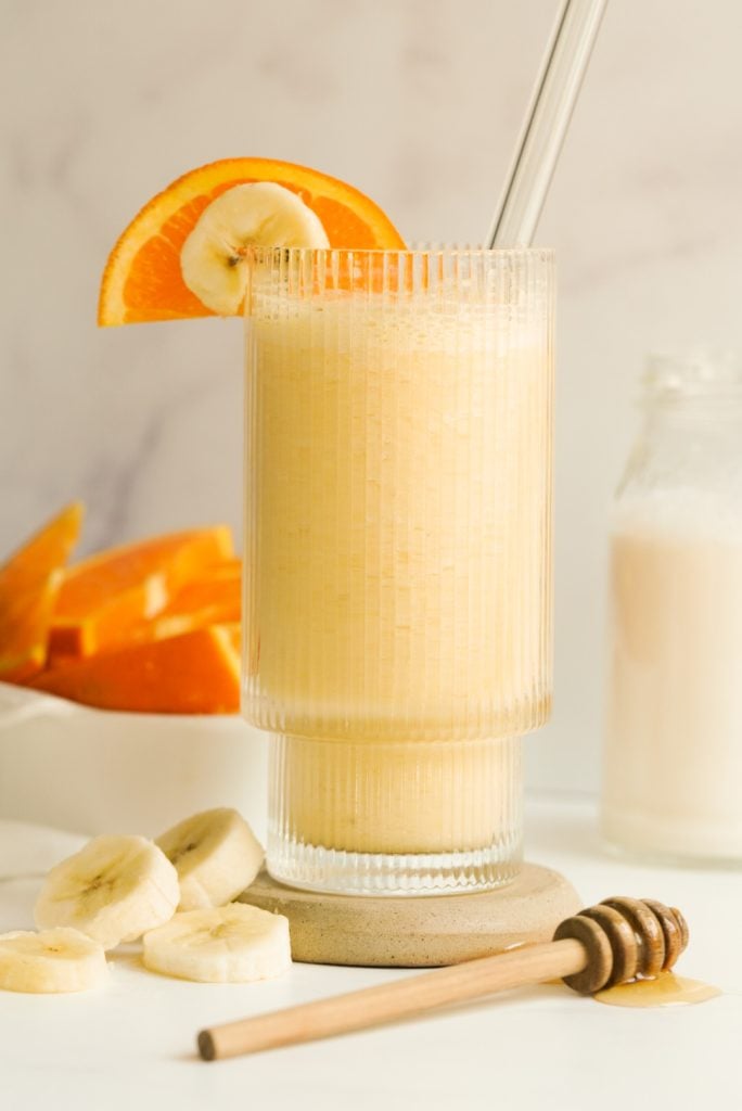 fresh orange smoothie in a drinking glass