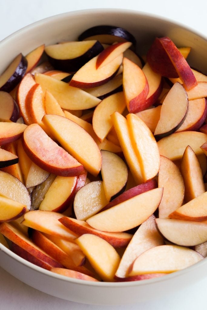 sliced stone fruit in a bowl.