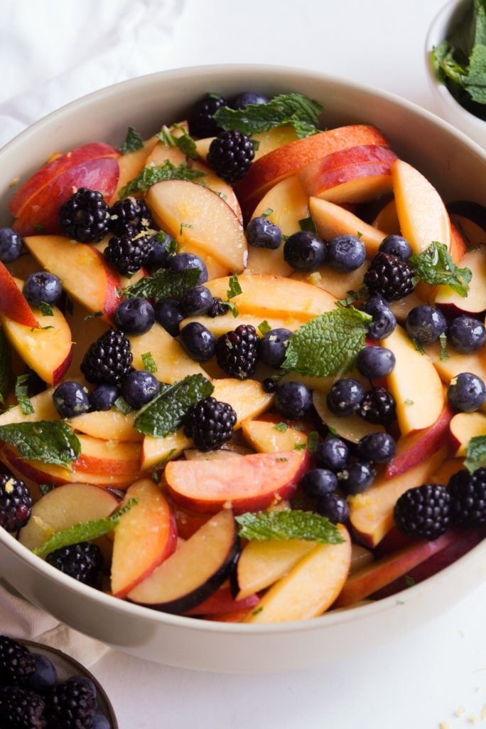 https://wellnessbykay.com/wp-content/uploads/2023/07/stone-fruit-salad-with-mint-684x1024.jpg