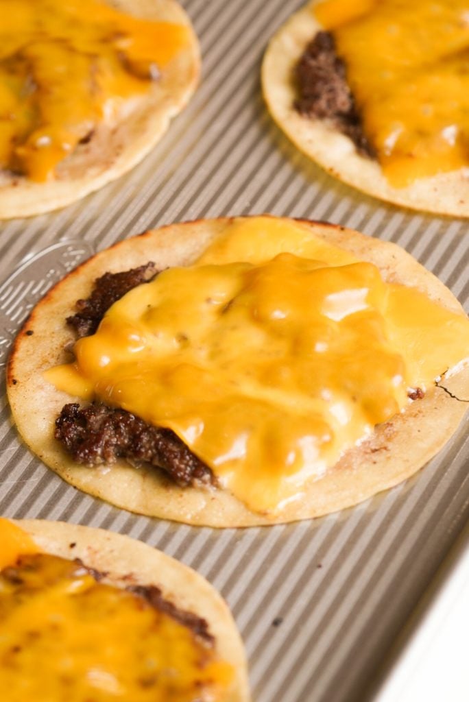 tortillas with smashed burger patties and melted cheese slices