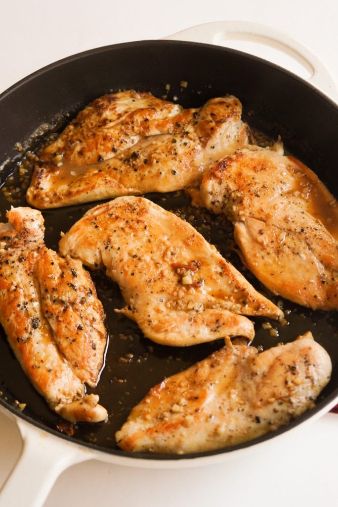 chicken breasts simmering in maple glaze