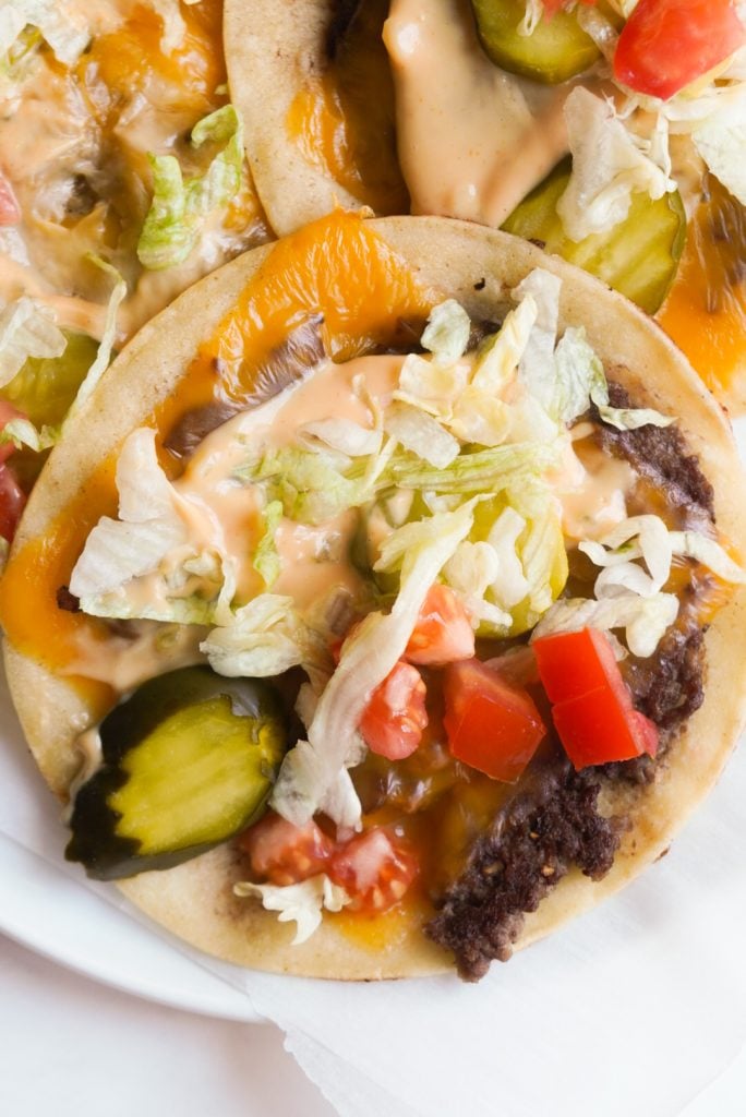 overhead shot of a smash burger taco with big mac sauce and toppings
