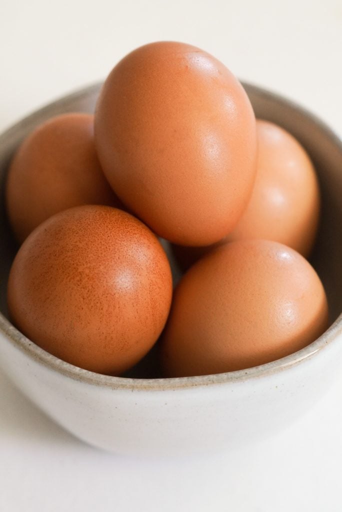 a small bowl of brown eggs