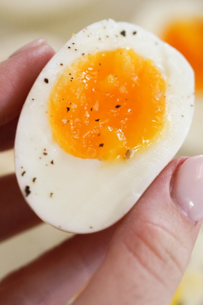 hand holding a jelly jam-like egg half