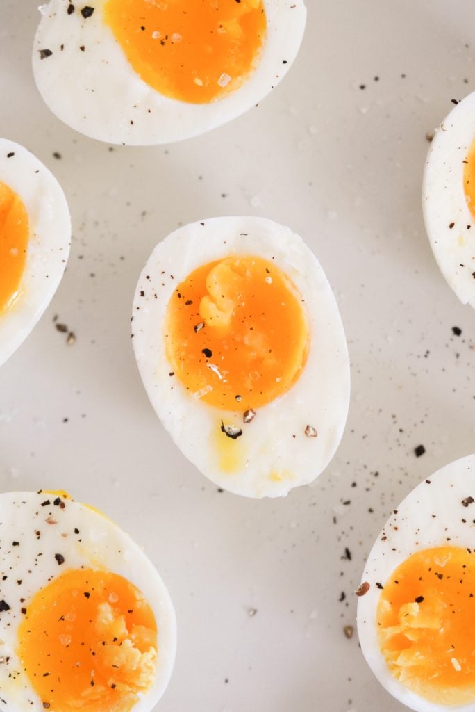 a plate of 7 minute eggs topped with salt and cracked black pepper