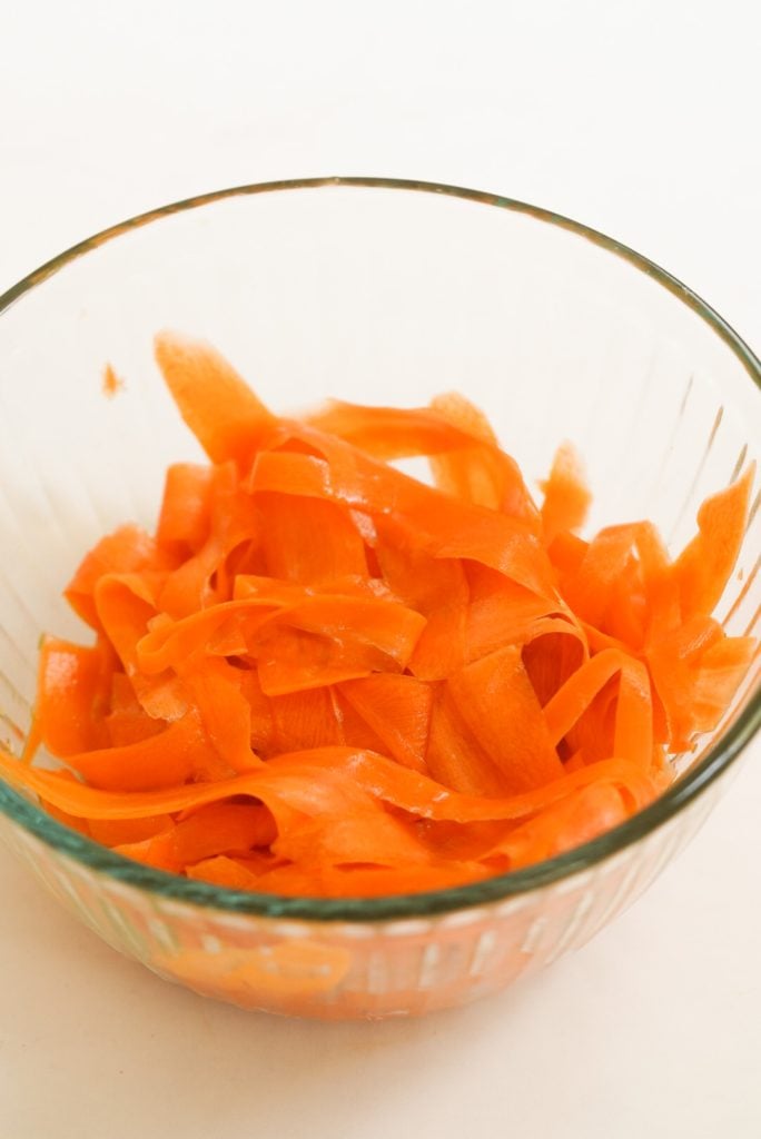 carrot ribbons in a mixing bowl