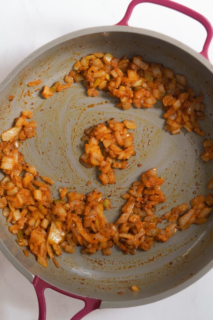overhead shot of diced onion that has been sauteed with spices.