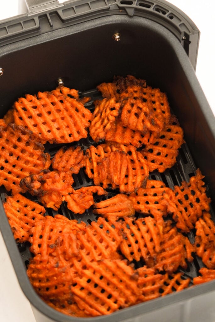Frozen sweet potato waffle fries in the air fryer after cooking