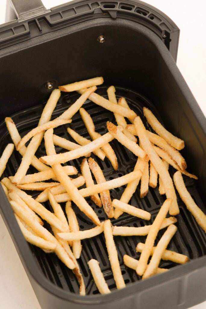 Frozen fast food style fries in the air fryer before cooking