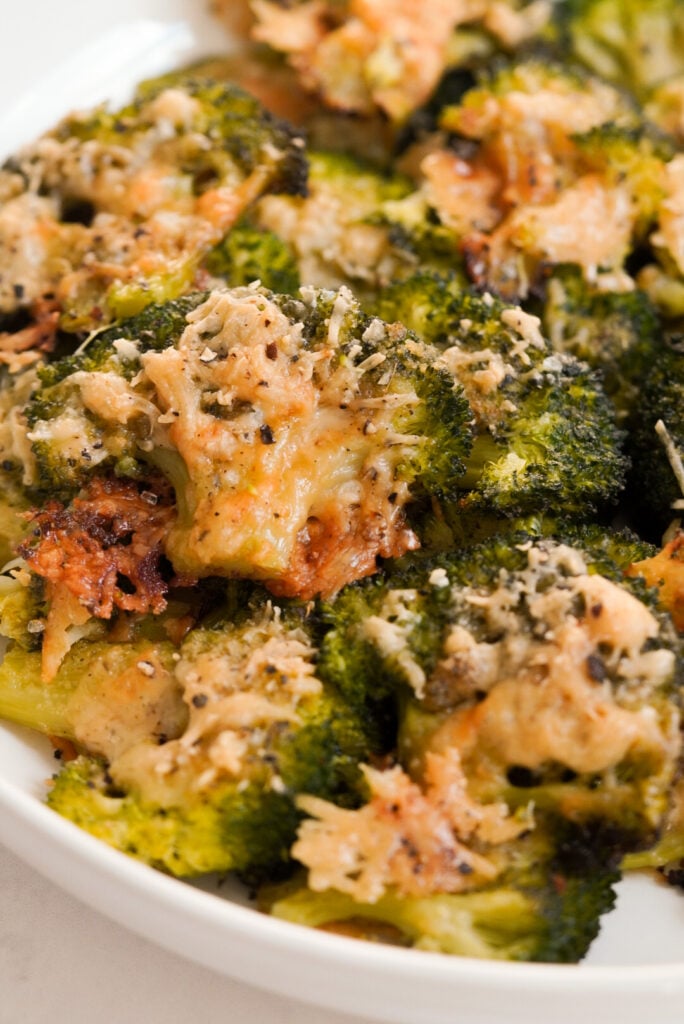 bowl of crispy smashed broccoli florets with parmesan cheese.