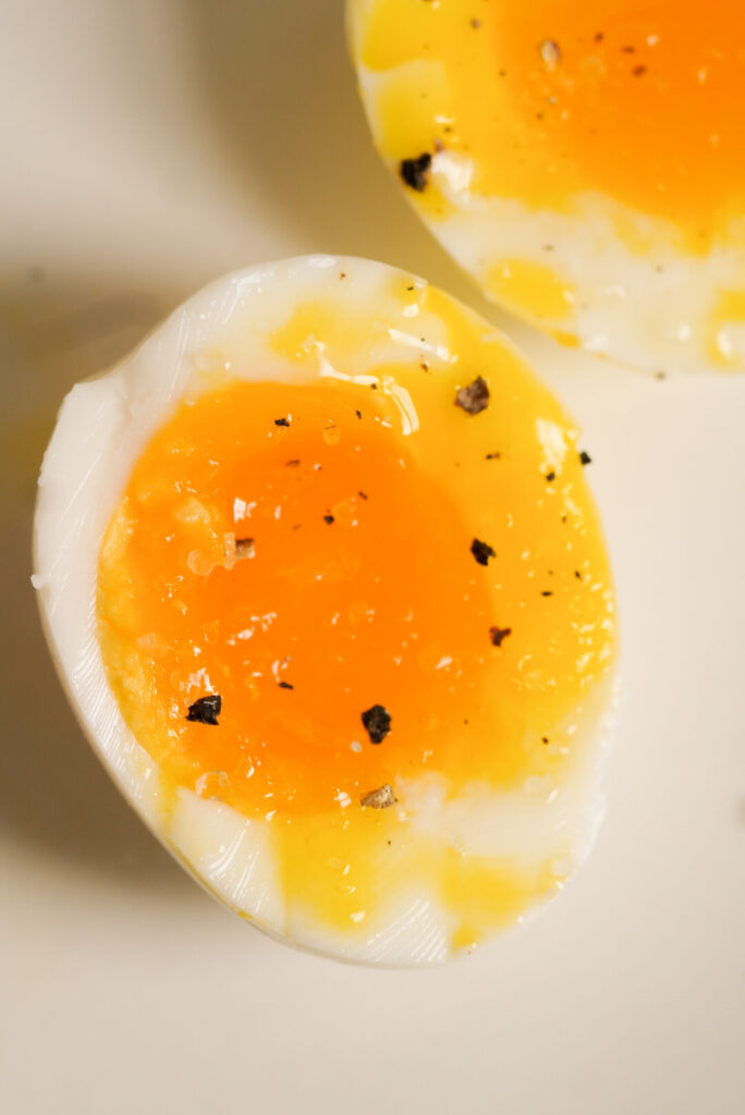 overhead shot of a soft boiled egg with salt and pepper