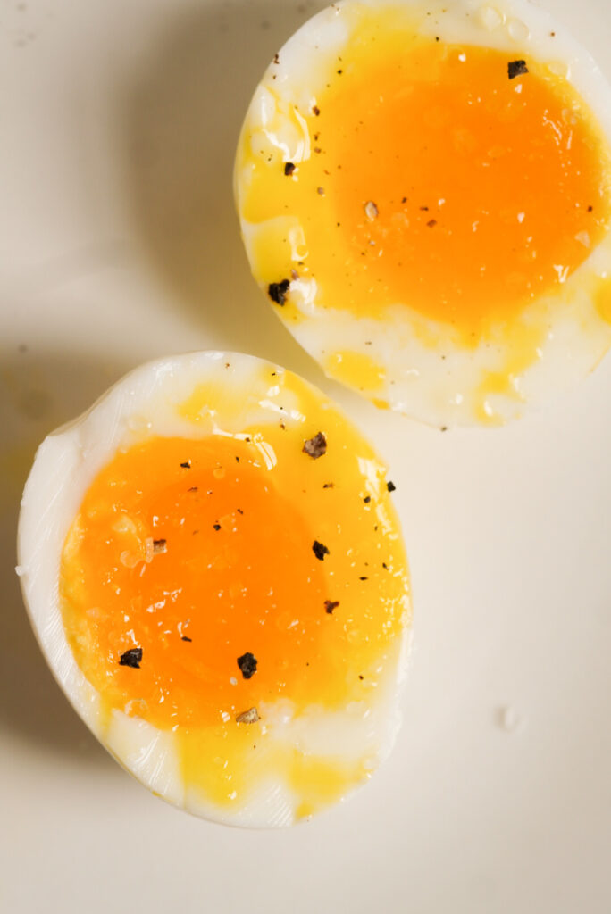 boiled egg cut in half with salt and pepper