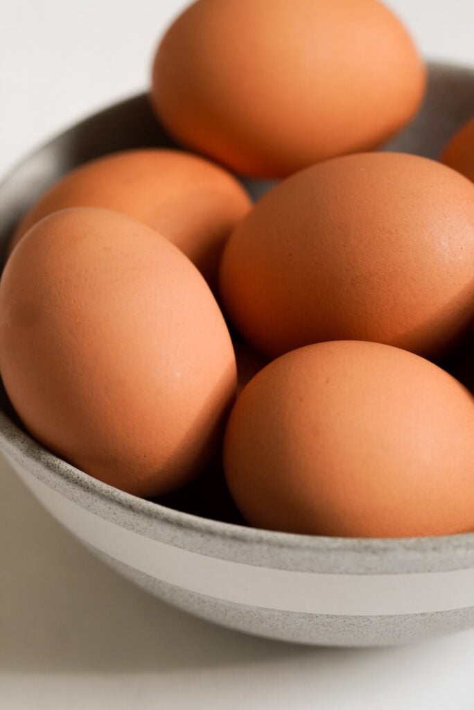 close up shot of raw eggs in a bowl