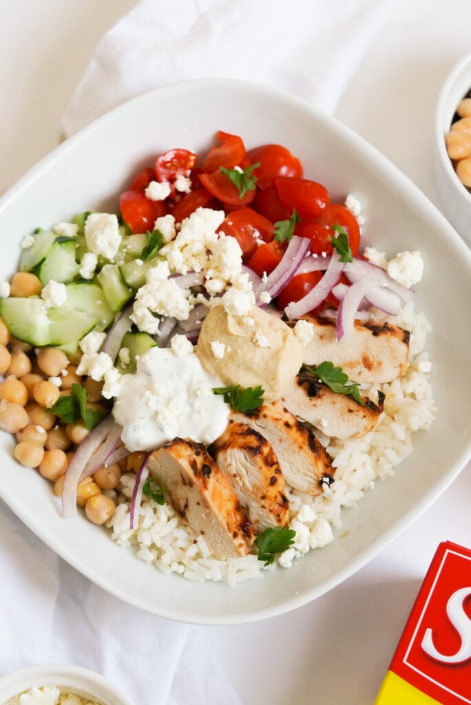 greek chicken and white rice bowl with fresh veggies 