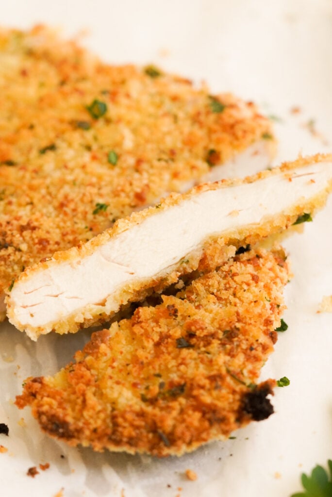 closeup shot of a slice of oven baked chicken cutlet.