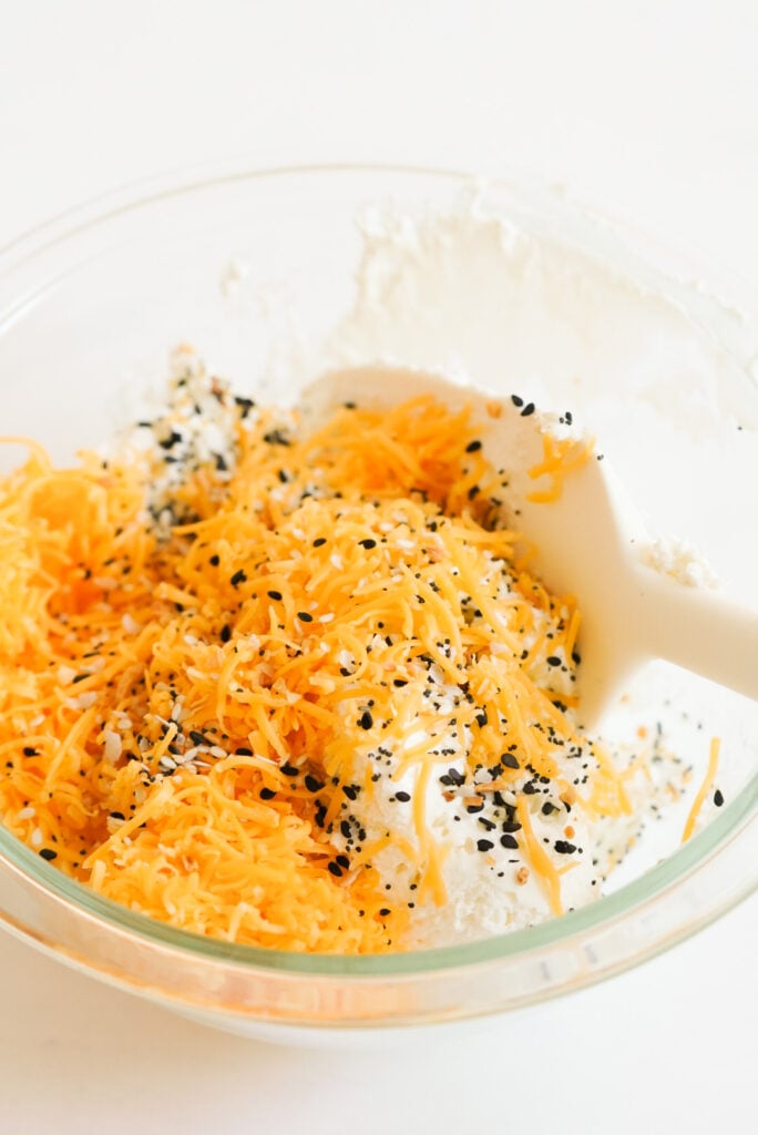 cream cheese, shredded cheddar cheese, and bagel seasoning in a mixing bowl