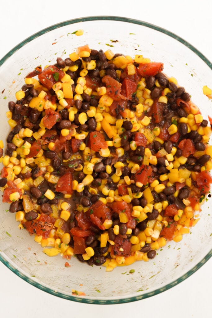 process shot showing corn and black bean salsa in the mixing bowl after mixing.