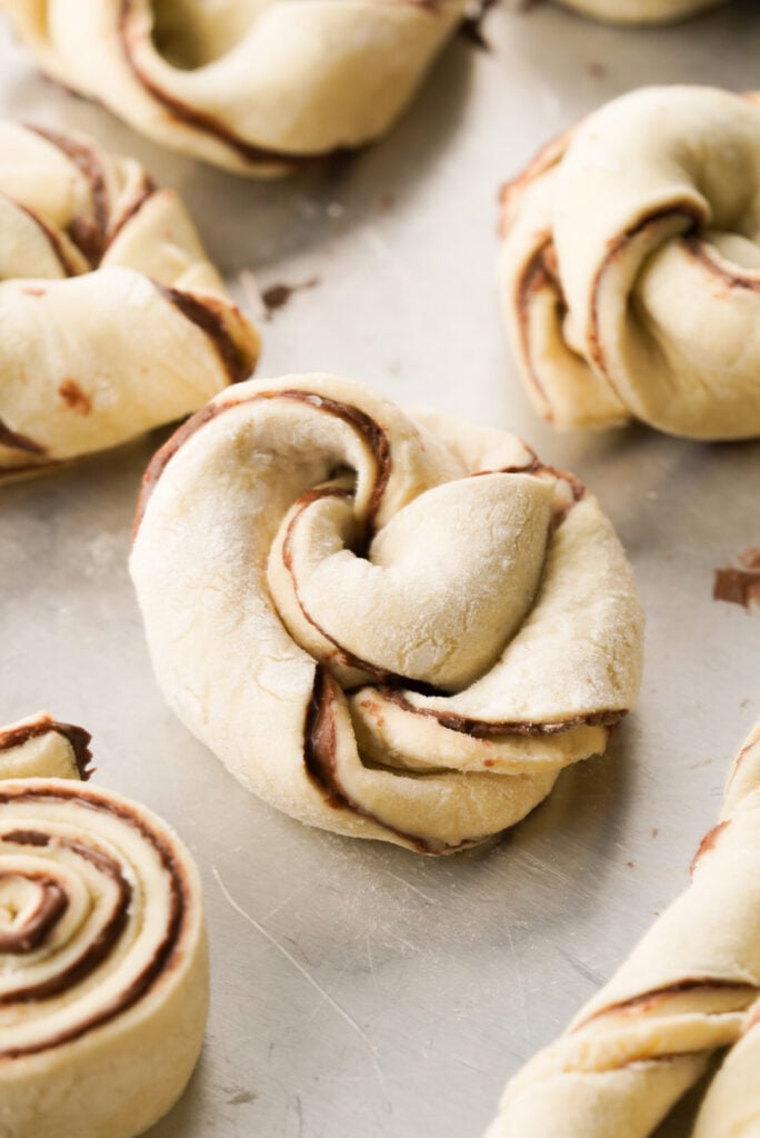 puff pastry knots with chocolate spread before baking