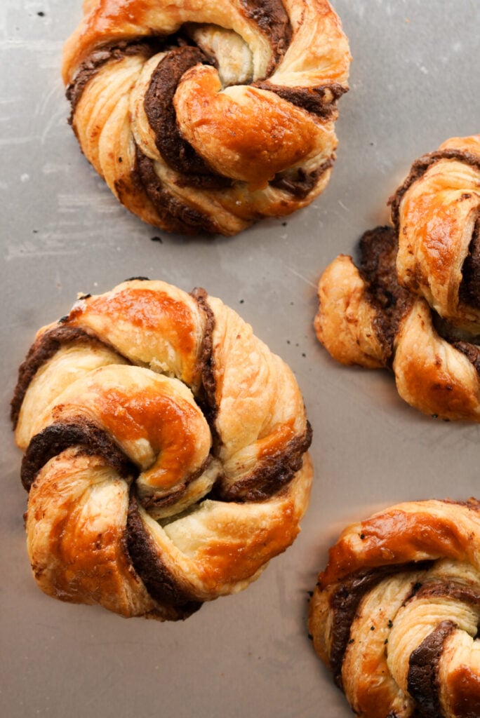 nutella puff pastry knots on a baking sheet