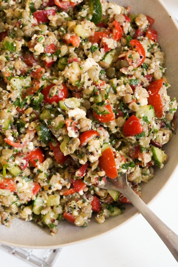 quinoa salad with lentils, feta cheese, fresh veggies, and fresh herbs